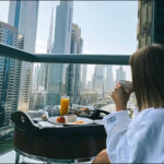 Dubai breakfast buildings balcony people woman