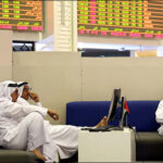 Traders monitor stock information at Dubai Financial Market