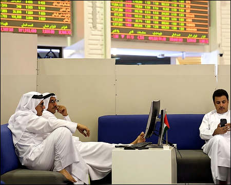 Traders monitor stock information at Dubai Financial Market